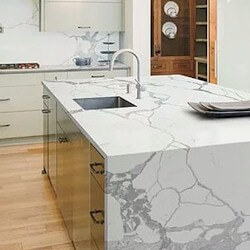 Calacatta white background with dynamic light grey veining kitchen island with waterfall.