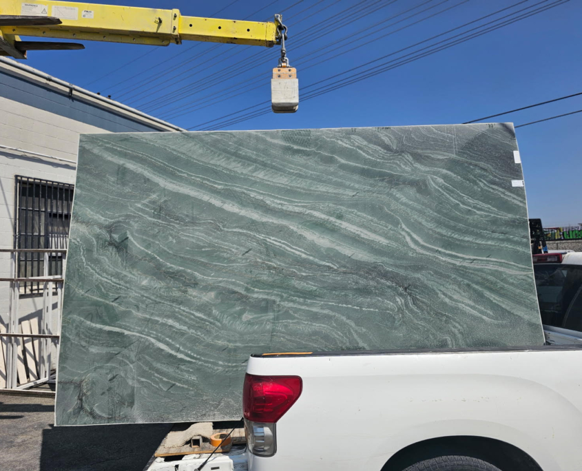 Rich green background(s), often multiple tones of green. Often with secondary veining/colors: whites, browns, rusts, golds. Some slabs have dramatic, bold veining; others are more subdued.
