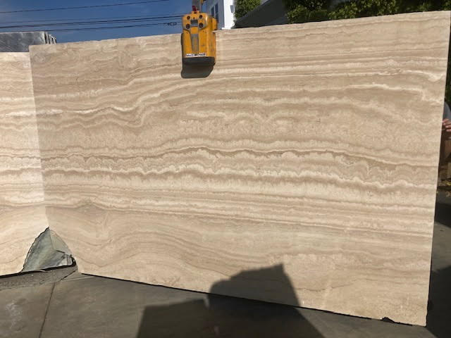Cream, beige, tan, silver, and walnut tones; natural holes/voids and layered bands are typical